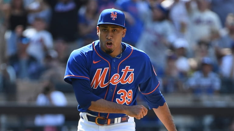 Mets relief pitcher Edwin Diaz reacts after he struck out...