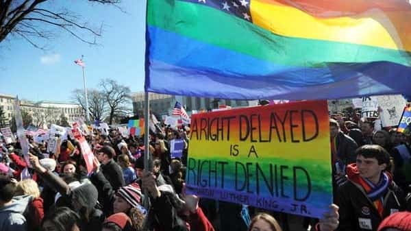 Same-sex marriage supporters shout slogans in front of the US...