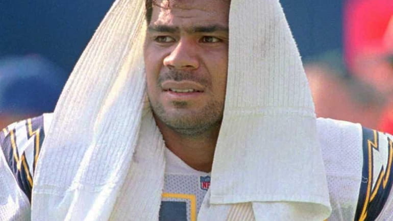 San Diego Chargers' Junior Seau rests on the sideline after...