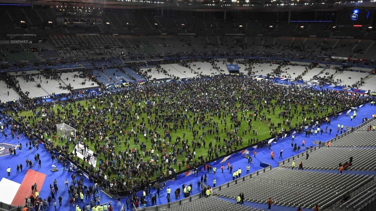 Spectators gather on the pitch of the Stade de France...