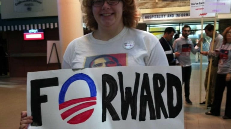 Hofstra University senior Cyndi Robuck, 21, holds up a sign...