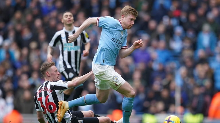Manchester City's Kevin De Bruyne, right, is tackled by Newcastle's...