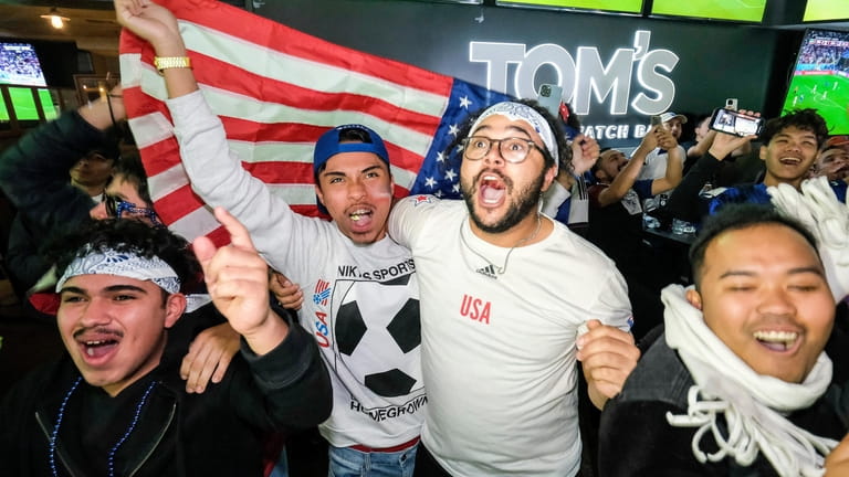 U.S. soccer fans celebrate at a watch party after their...