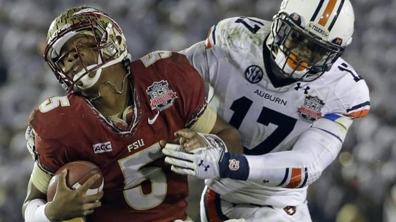 Auburn's Kris Frost tackles Florida State's Jameis Winston on a...