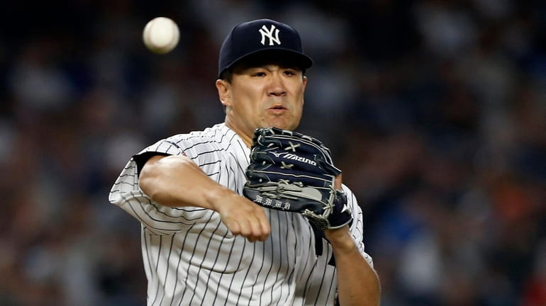 Masahiro Tanaka, firing to first base, pitched a shutout as...