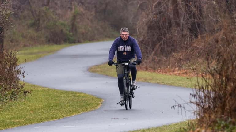 A rider on the Bethpage Bikeway, a bike trail that passes...