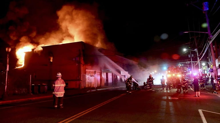 Firefighters battle a blaze at the corner of Woodfield Road and...