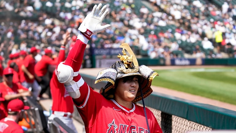 Los Angeles Angels' Shohei Ohtani celebrates in the dugout after...