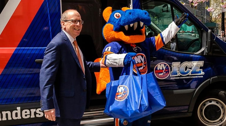 Islanders co-owner Jon Ledecky arrives with team mascot Sparky at...
