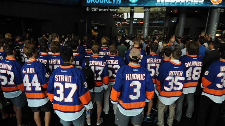 Members of the New York Islanders organization gather at the...