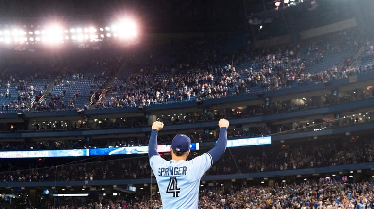 George Springer #4 of the Toronto Blue Jays salutes the...