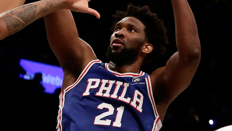 Joel Embiid of the 76ers puts up a shot during the...