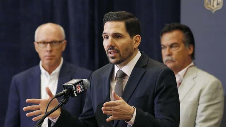 Dean Blandino, middle, NFL vice president of officiating, answers a...