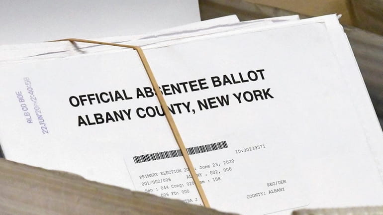 File photo, a box of absentee ballots wait to be...