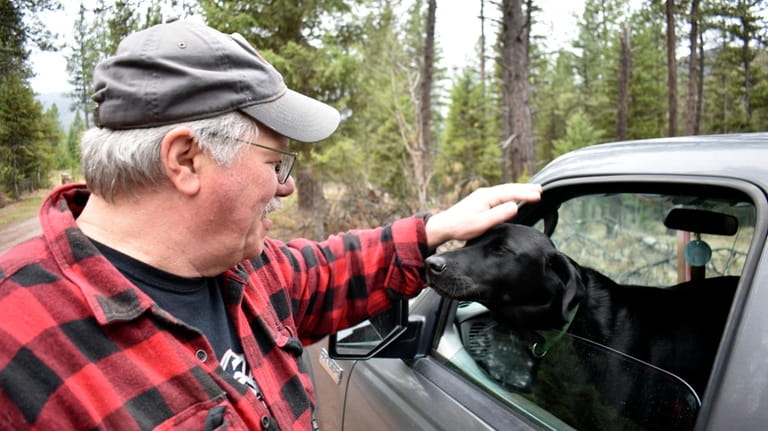 Paul Resch is seen petting his dog Mr. Bojangles after...
