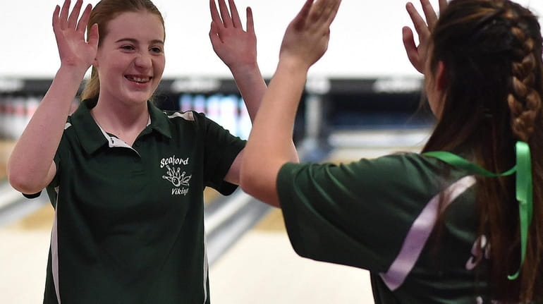 Marissa Mele of Seaford, left, gets congratulated by teammate Paige...