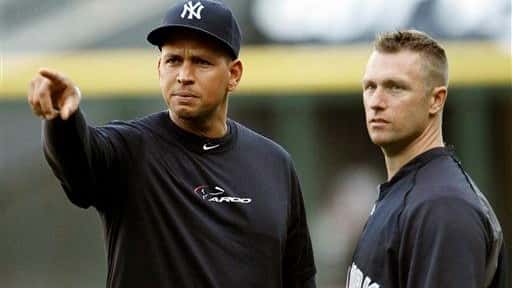 Alex Rodriguez, left, gestures alongside strength and conditioning coach Dana...