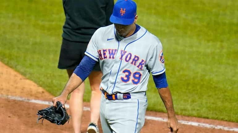 New York Mets relief pitcher Edwin Diaz walks off the...