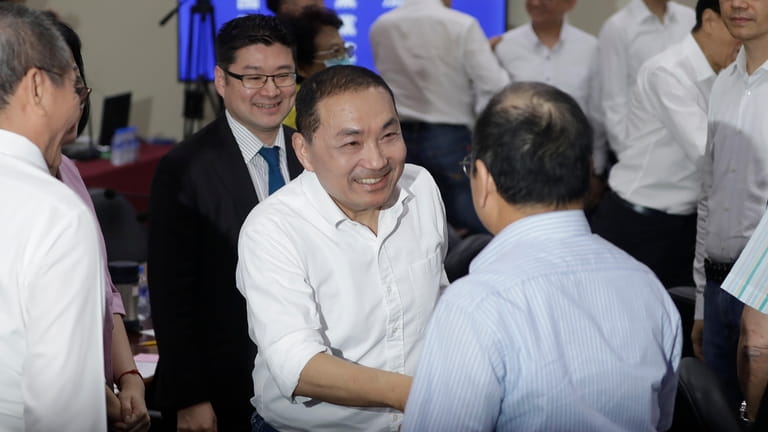 New Taipei City Mayor Hou You-yi shakes hands with party...