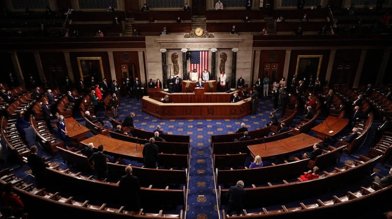A social-distanced, reduced-capacity House chamber hosts Joe Biden's first presidential...