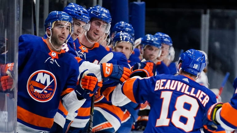 Islanders' Anthony Beauvillier (18) celebrates with teammates after scoring a...