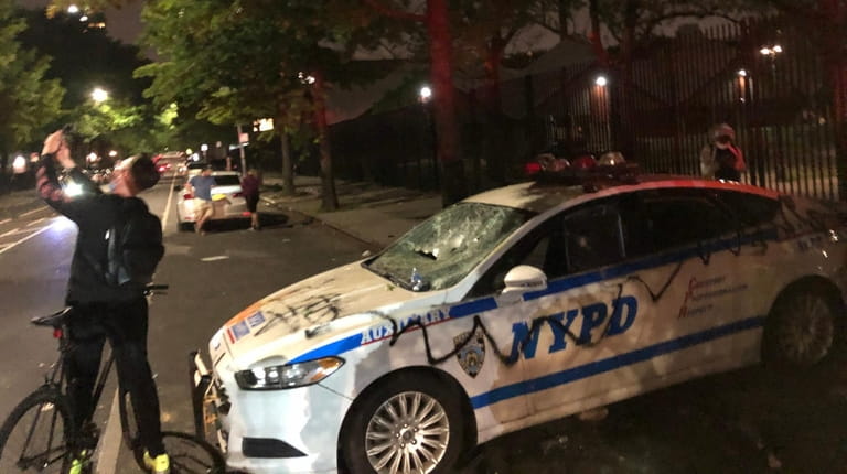 A vandalized NYPD vehicle on DeKalb Avenue in Brooklyn outside the...