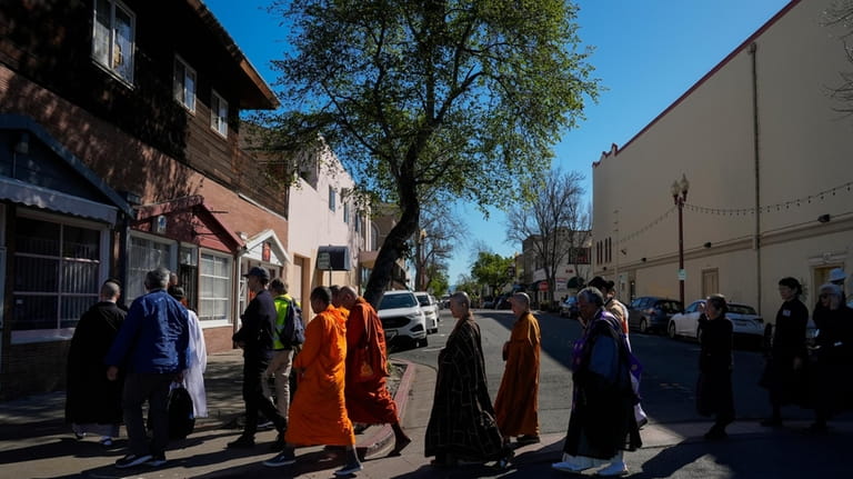 Buddhist faith leaders and community members participate in a "May...