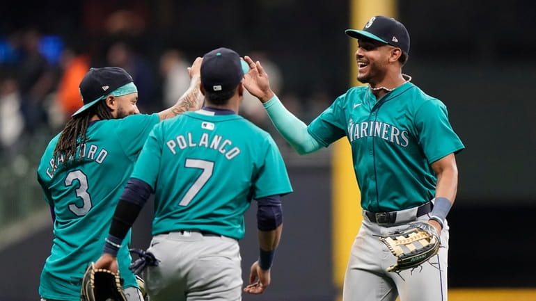 Seattle Mariners' Julio Rodríguez, right, celebrates with J.P. Crawford (3)...