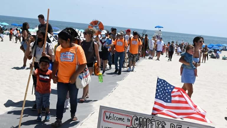 Shinnecock members and their allies rally at Cooper’s Beach in Southampton...