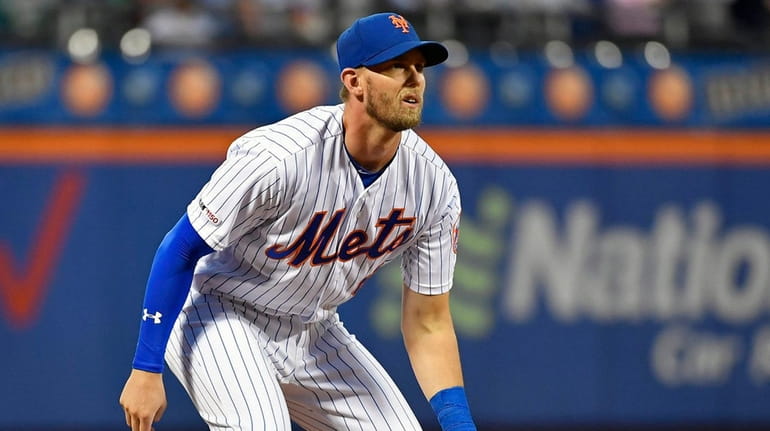 Mets third baseman Jeff McNeil looks on against the Cubs...