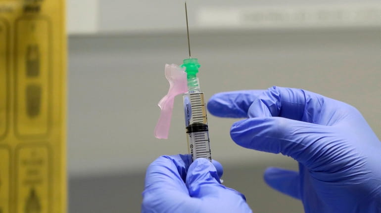 A potential COVID-19 vaccine is shown at a clinic in London...