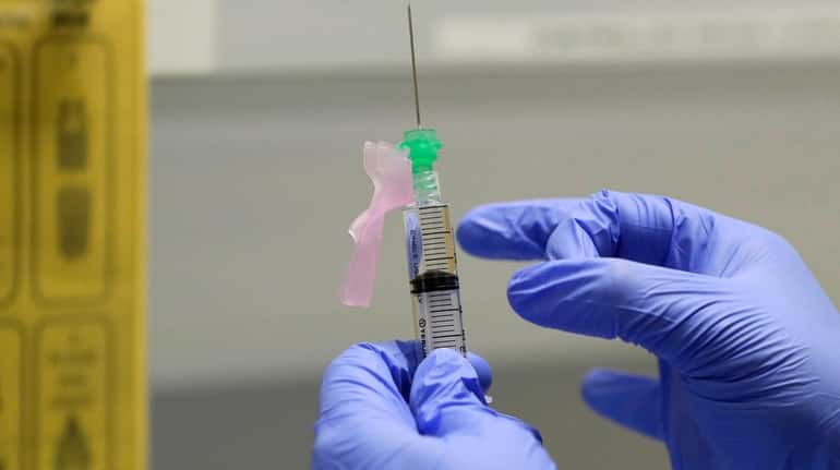 A potential COVID-19 vaccine is shown at a clinic in London...
