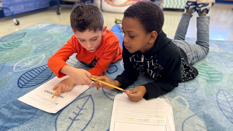Babylon Elementary School students partner for a writing assignment that aims to...