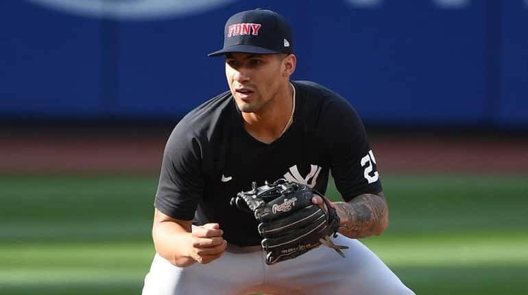 New York Yankees shortstop Gleyber Torres warms up wearing a...