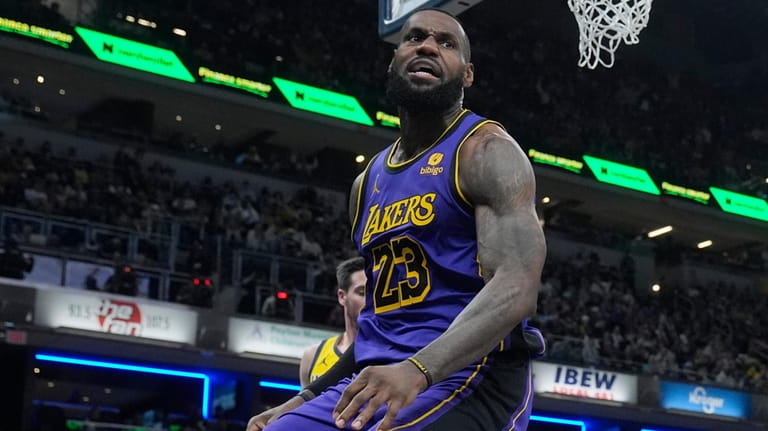 Los Angeles Lakers' LeBron James (23) reacts after a dunk...