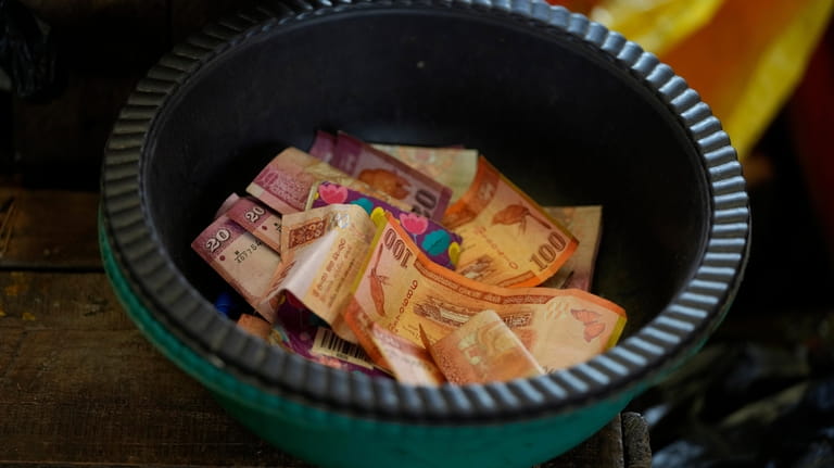 Sri Lankan currency notes are kept in a bowl at...