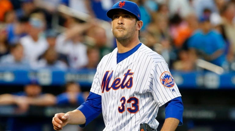 Matt Harvey of the Mets walks to the dugout against...