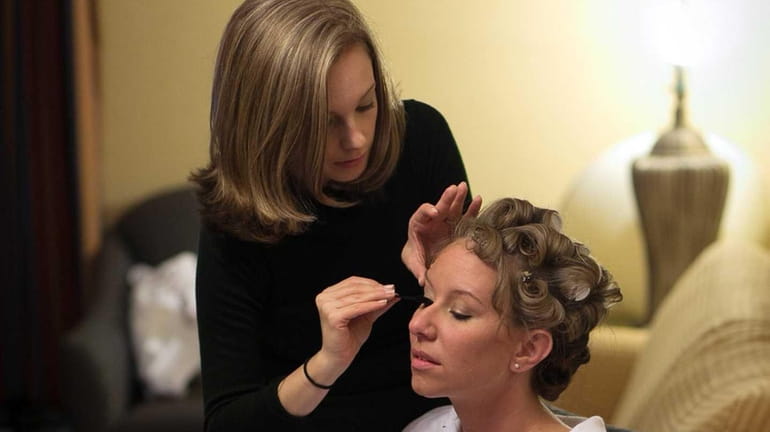 Mape-up artist, Sally Biondo applying makeup to bride Nicole Gibson...