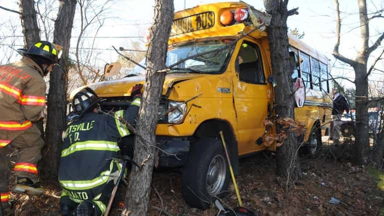 Firefighters at the scene of a mini-school bus crash along...