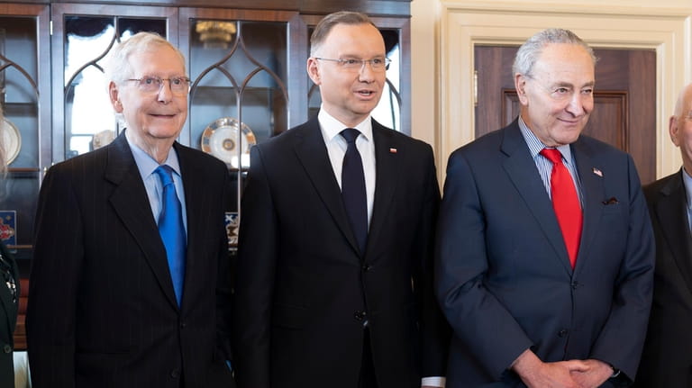Polish President Andrzej Duda, center, is welcomed for talks with...