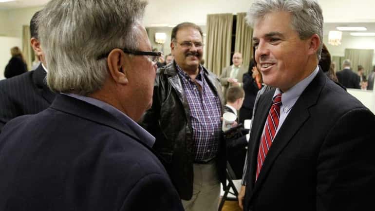Newly elected Suffolk County Executive Steve Bellone, right, greets Chamber...
