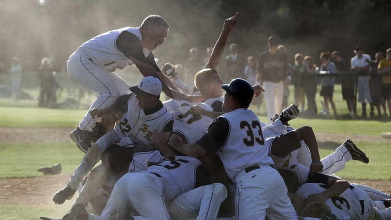 Shoreham baseball players celebrate their county championship victory over Sayville....