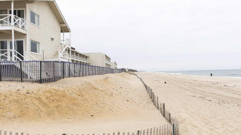 A series of fences and sand berms along a former...