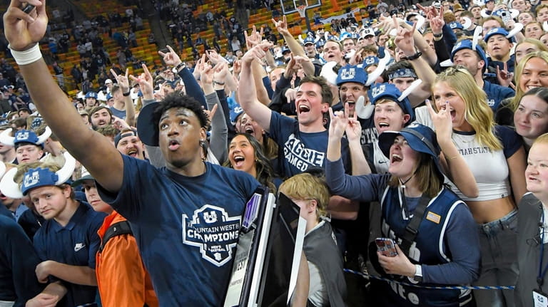 Utah State forward Great Osobor celebrates with fans after the...