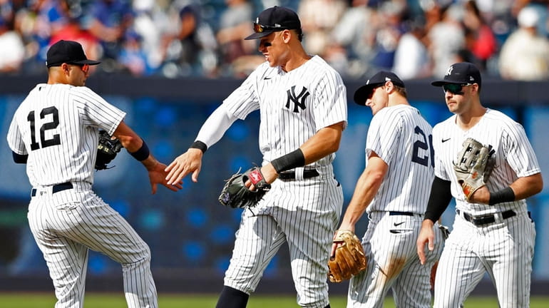 Yankees shortstop Isiah Kiner-Falefa and rightfielder Aaron Judge celebrate after defeating...