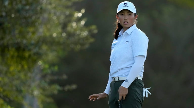 Ruoning Yin, of China, watches her shot on the 17th...