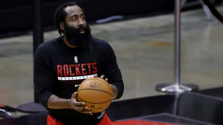 The Rockets' James Harden warms up prior to an NBA...