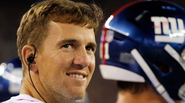 Giants quarterback Eli Manning watches the preseason game against New...