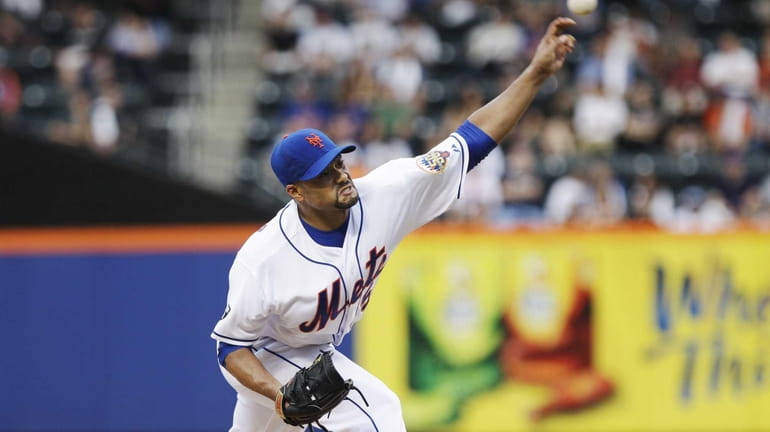 New York Mets' Johan Santana delivers a pitch during the...