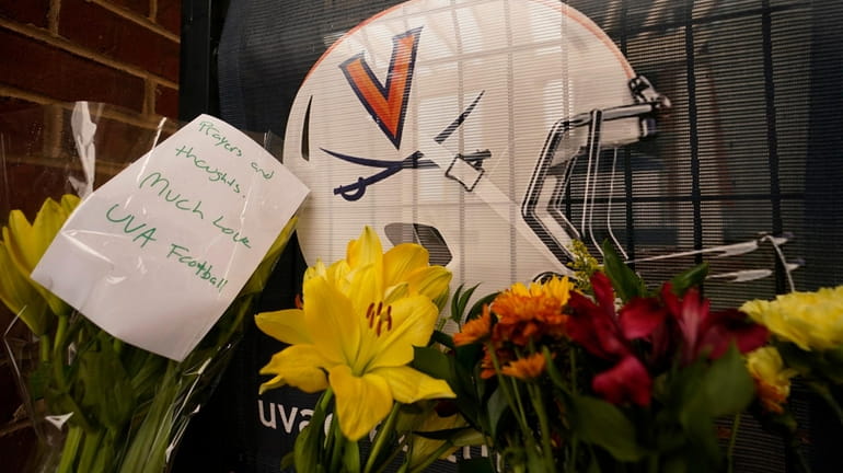 Memorial flowers and notes line walkway at Scott Stadium after...